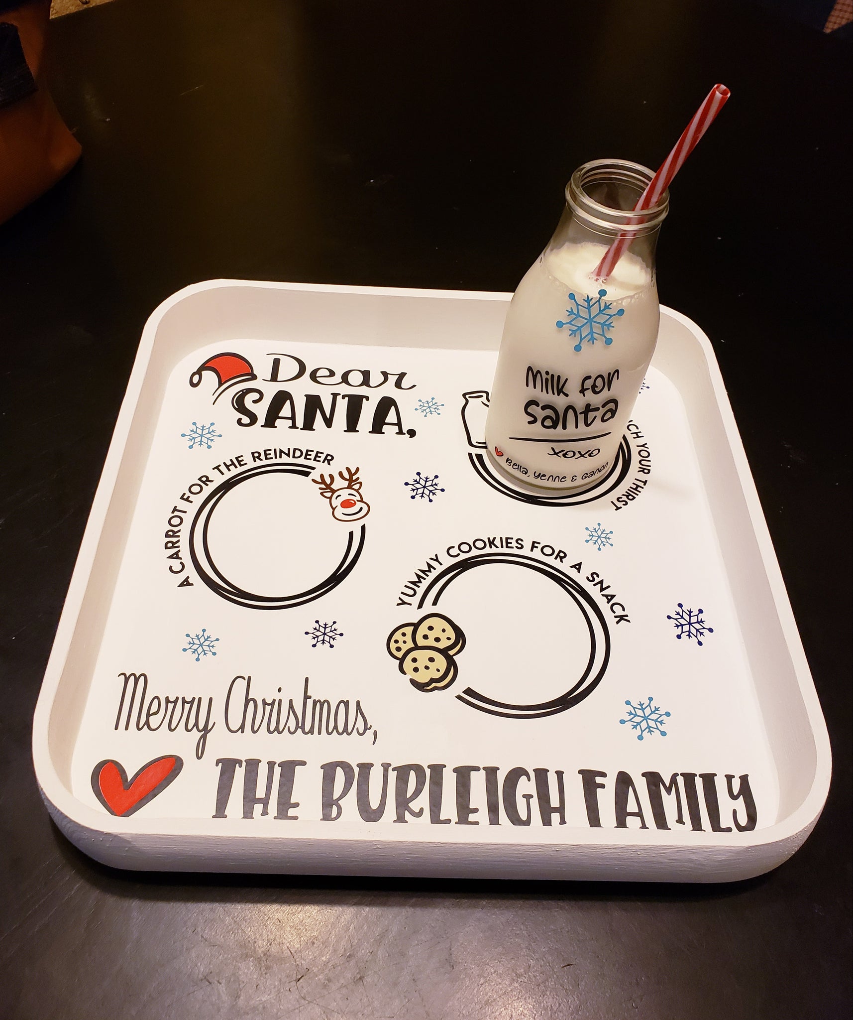 This beautiful hand-painted Santa Tray Set is perfect for keeping your Christmas spirit alive! This personalized set includes a 12 x 12 tray and a 15 oz glass milk bottle. Personalize it with your family last name and up to 3 children's names - it will be a cherished family heirloom for years to come. Delivery of your set is estimated to take 5 to 7 days.