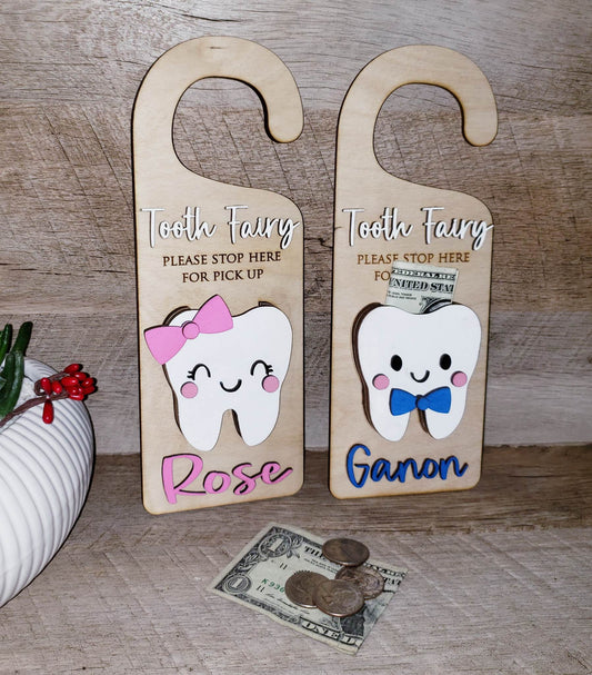 Make your child's tooth-losing experience even more magical with this Tooth Fairy Door Hanger, crafted with laser-cut birch wood and acrylic paint! Choose your hanger with a boy or girl design, and personalize with a name – or leave blank to use for the entire family. Triple layer "tooth cup" keeps money safe and secure - though we don't suggest leaving it there for too long! Make every tooth loss a special one!