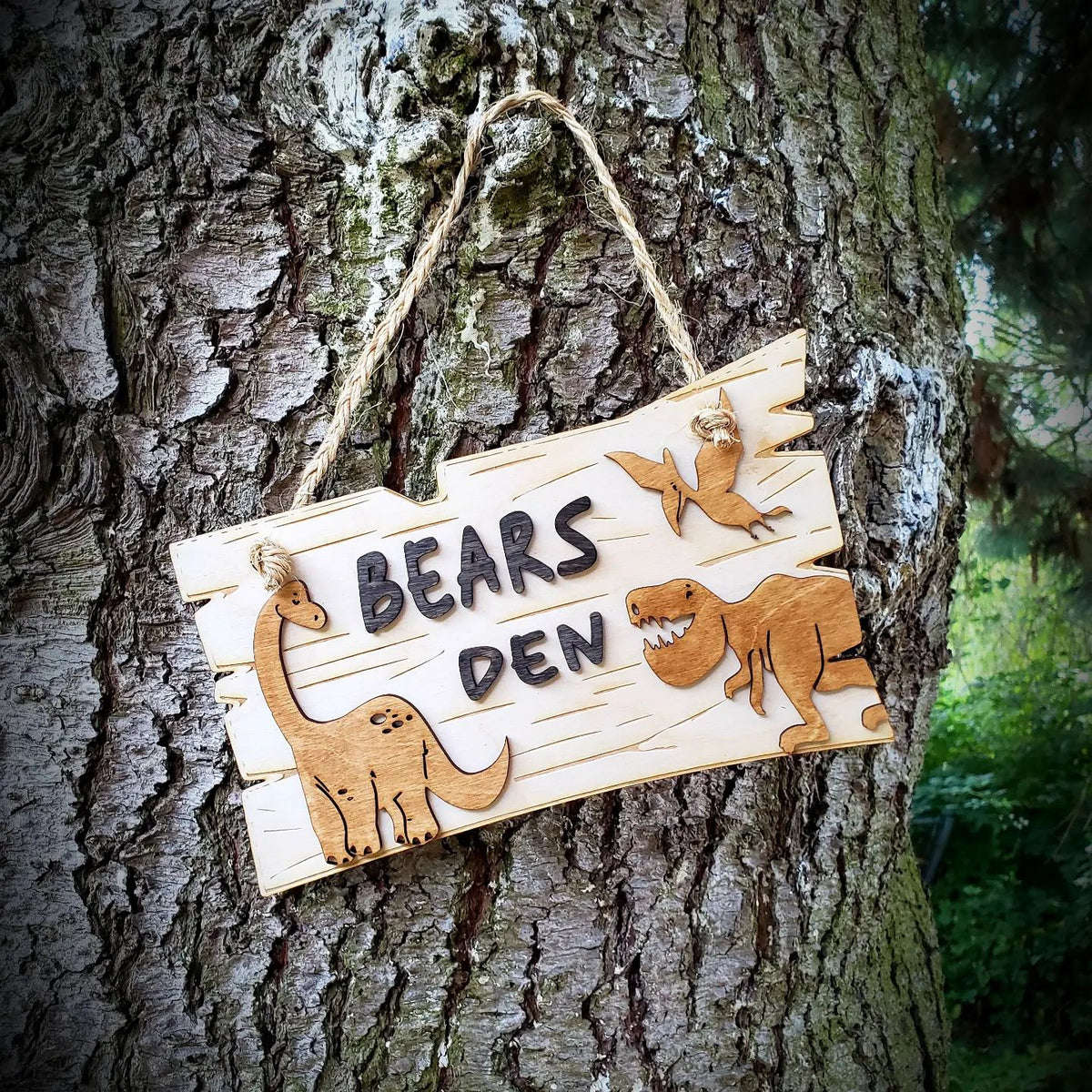 Create a lasting impression in any dino-lover's home with this beautiful, personalized Dinosaur Sign. Made of birch wood with a rustic, wood-grained finish, it features intricately laser-engraved dinosaur cutouts. The perfect addition to your club house, den, bedroom, or tree house, the sign will ship in 5-7 days.