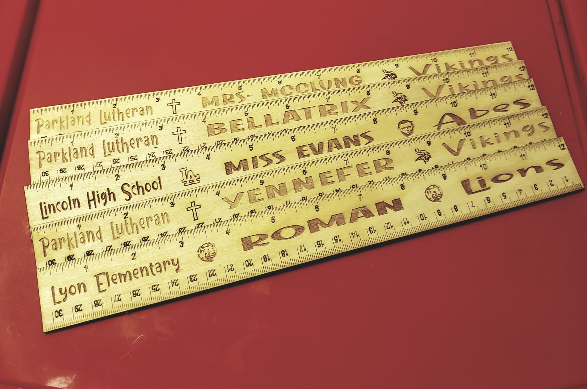 This cute 12" personalized ruler is full of school spirit!  Engraving contains Child/Teachers name, School name and mascot name, or be creative and choose your own inspirational saying.  Design includes your choice of a cross, a heart, an apple, and even a school mascot if provided  Rulers are handcrafted and made from Birch Wood.  Items may show diff wood grains and the tone or darkness of the engraving may differ as it is the natural flow and coloring of the wood.  