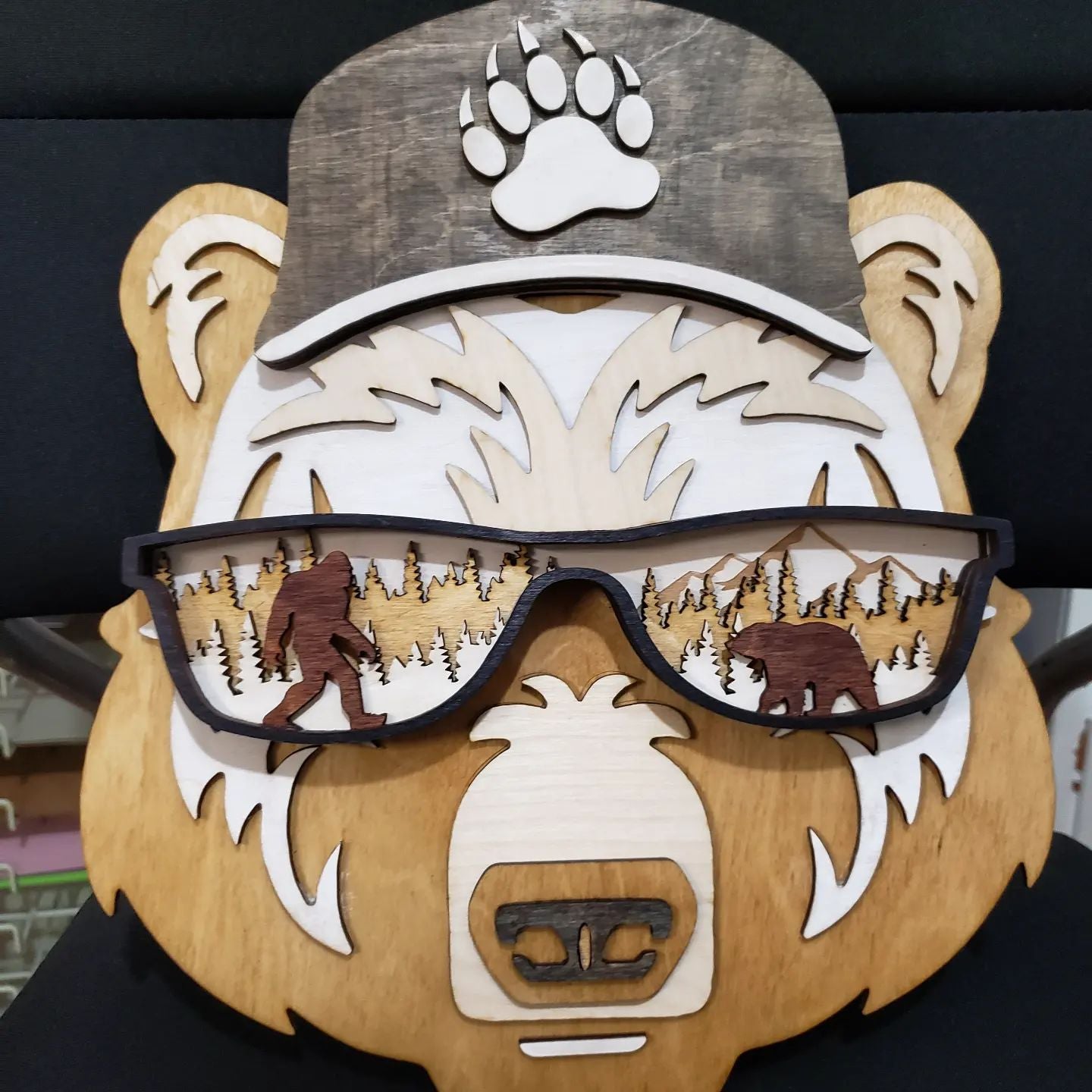  Add a unique touch to your home decor with the Bear Wall Decor. This 7-layer, laser cut wooden wall art features a hand-painted bear head, reflecting both bigfoot and nature. It's crafted from birch wood and is shipped within 5 to 7 days. Make a statement with this one-of-a-kind wall piece!