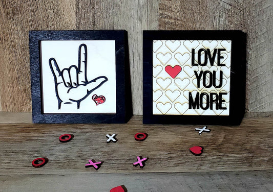 This 5" x 5" mini sign is an ideal present for that special person in your life. Perfect for display in tiered trays, walls or desks, the sign is crafted from Birch Plywood, painted with acrylic paints, laser cut and engraved with either 'I love you more' or 'ASL I love you'. Shipping time is 5-7 days.