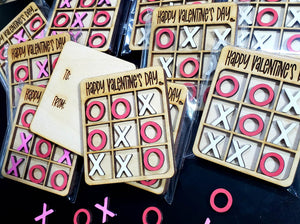Made for the perfect Valentine Classroom Parties, these Mini Versions of Tic Tac Toe come with 5 X's & O's or X's & Hearts and have to: and from: sides for kids or adults to complete. Each one measures 2.5" x 3" and is made from Baltic Birch and painted with acrylic paint. Packaged individually in self-sealing packages that can be resealed, but not suitable for small children due to choking hazard. Ships in 5-7 days.