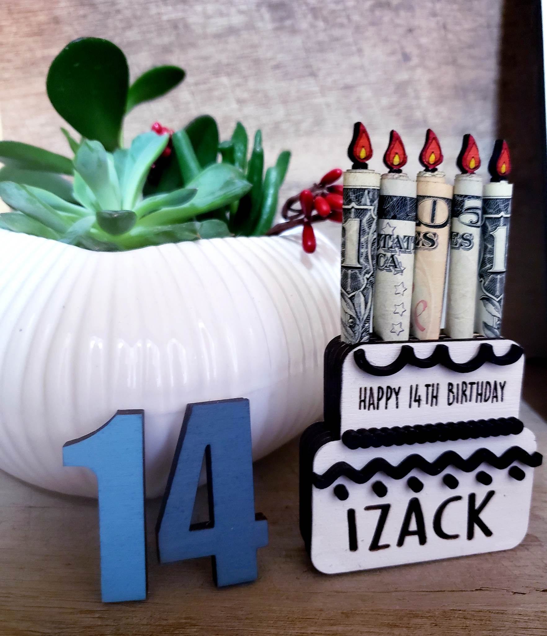 This hand painted Birthday Cake Money Holder is an ideal way to make someone's special day even more memorable. Crafted from laser cut birch wood, this decorative holder measures approx. 3.25 x 3" and comes in your choice of colors. Give the perfect gift with this unique celebration item.