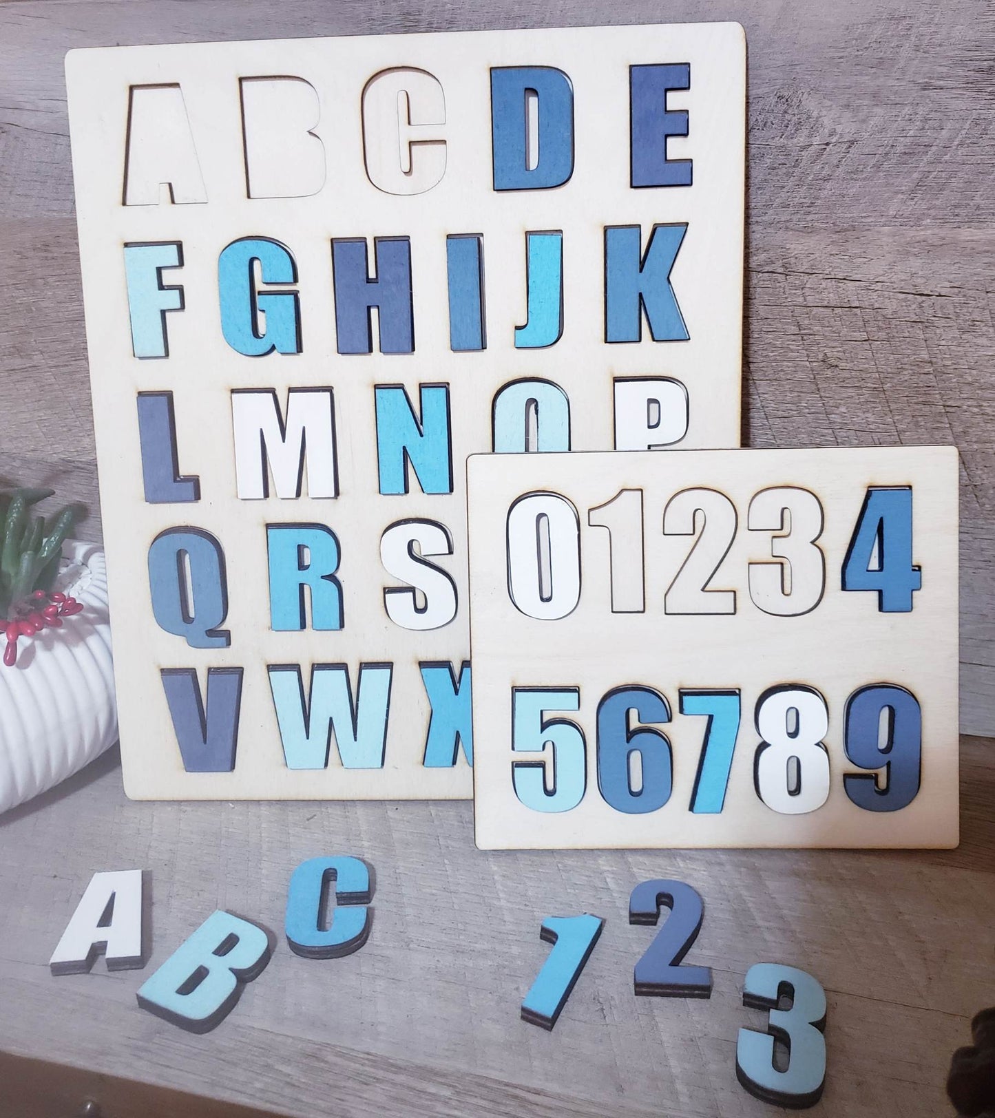 This ABC-123 Puzzle Bundle makes a perfect gift for children. It features two handcrafted Birch Wood puzzles with ABCs and 123s, designed to help children learn and explore in a fun way. The ABC puzzle measures 10x12 while the 123 puzzle measures 7x6, making them an excellent size for little hands. All puzzles are made with love and ship within 5-7 business days.