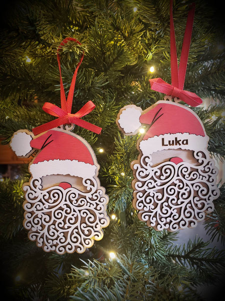   Kick off your festive season with the best secret Santa ever: the Santa Ornament! Crafted from laser-cut Birch wood, it's hand-painted with acrylic and chalk paints. Whether you hang it on your tree or use it as a gift tag, this 4"x5" ornament is personalized with the name of your choice. Ready to ship in 5-7 days - what're you waiting for? Ho ho ho!